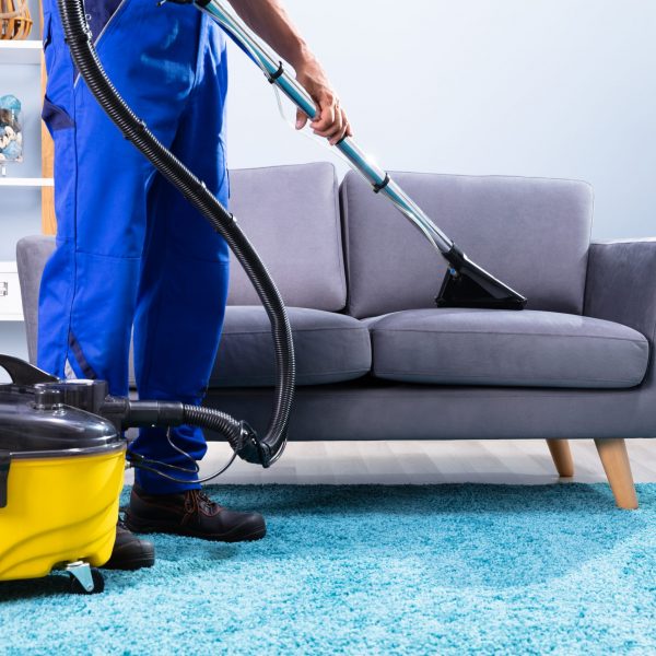 Photo Of Person Cleaning Sofa With Vacuum Cleaner